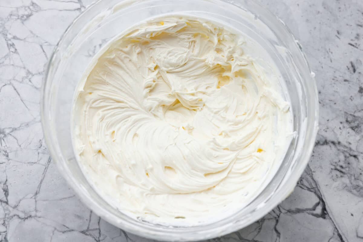 You guys are going to love how refreshing and flavorful this cucumber dip is. It's the perfect mix of creamy and crunchy and comes together in minutes! Cream cheese and sour cream whipped together in a mixing bowl.