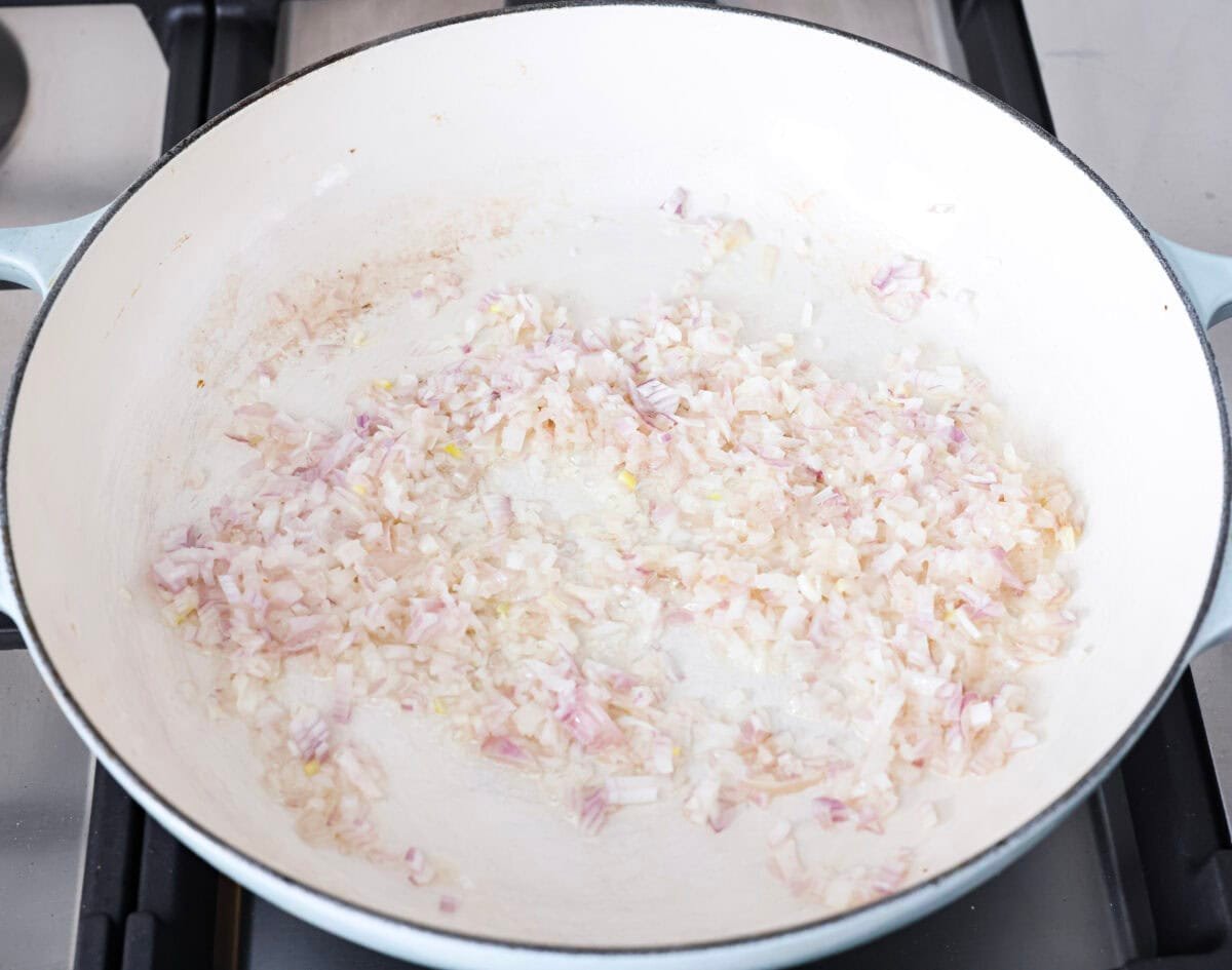 Fresh lemons make me so happy! They’re bright, cheerful, and lift me out of the winter rut. Add that citrusy sunshine to a creamy pasta, and you get this dreamy Creamy Lemon Orzo! Simple, rich, and bursting with feel-good flavor. Shallots and butter cooking in a skillet.
