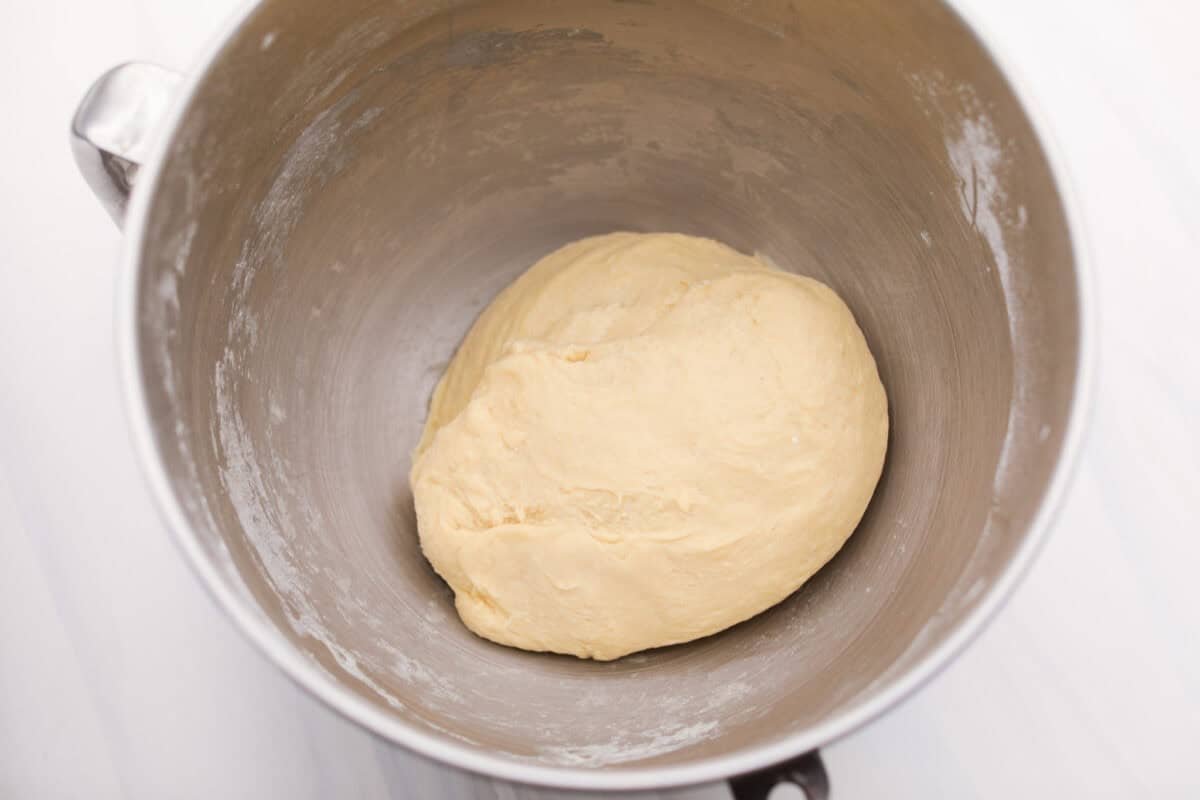 Strawberry cinnamon rolls are going to become a tradition in your house after you make these! The secret is the freeze-dried strawberries mixed with the lemon zest in the glaze - the flavor is to die for! Dough ball resting in the bottom of the stand mixer bowl.
