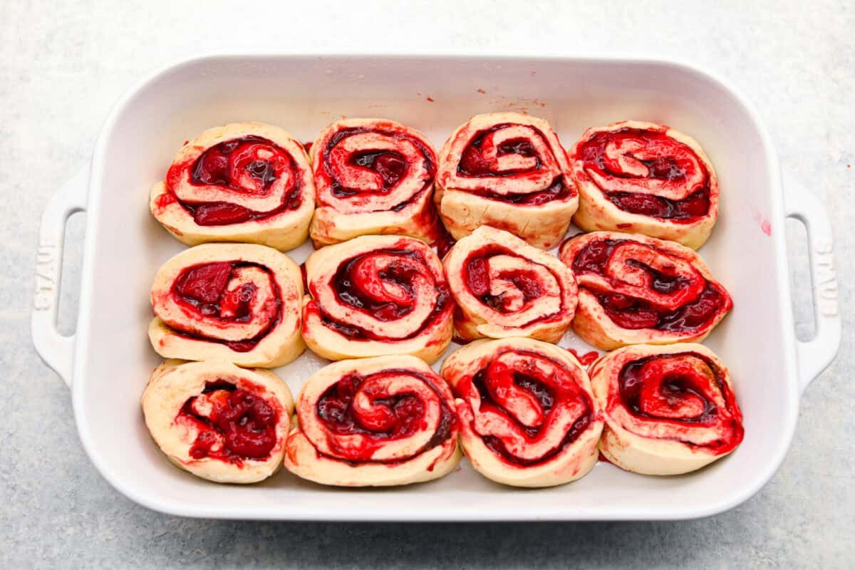 Strawberry cinnamon rolls are going to become a tradition in your house after you make these! The secret is the freeze-dried strawberries mixed with the lemon zest in the glaze - the flavor is to die for! Unbaked cinnamon rolls in a 9x13 baking dish.