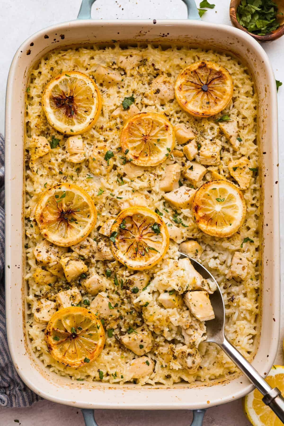 You guys love lemon chicken anything—and honestly, same. So I had to give you this lemon chicken casserole. With my signature made from scratch lemon herb sauce, you'll want this on repeat! Overhead shot of baked lemon chicken casserole in a baking dish.