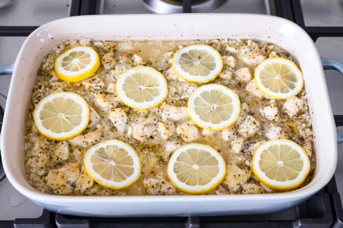 You guys love lemon chicken anything—and honestly, same. So I had to give you this lemon chicken casserole. With my signature made from scratch lemon herb sauce, you'll want this on repeat! Casserole par baked with fresh lemon slices on top ready to go back in the oven to finish cooking.