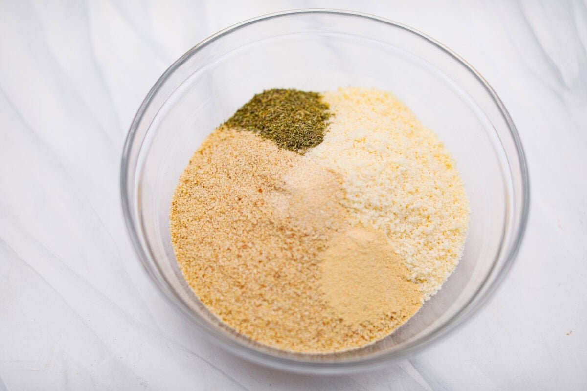 The secret to perfect mozzarella sticks comes down to three key steps: using the right mozzarella, double breading for a sturdy crust, and fully freezing them before frying. I’ve broken down these expert tips below! Bowl with breadcrumbs, cheese, and seasonings for the breading.