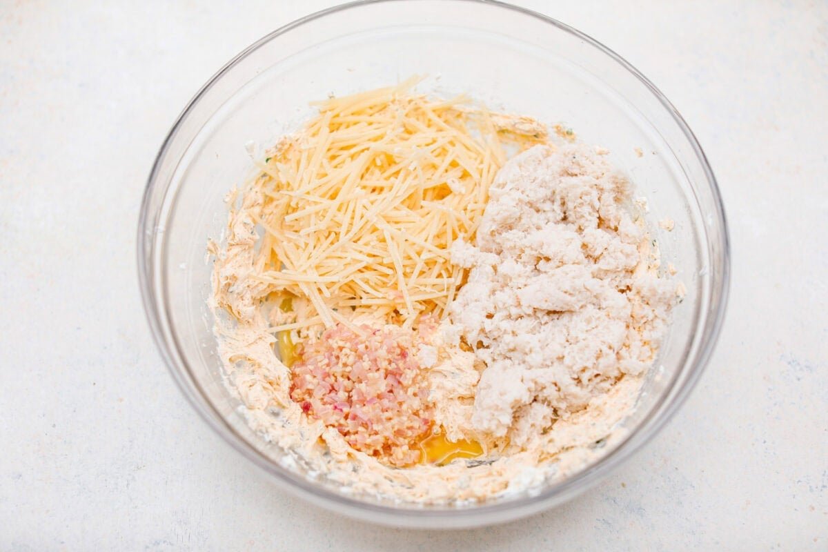 Overhead shot of the cream cheese mixture with cheese, crab meat, garlic and shallot mixture.