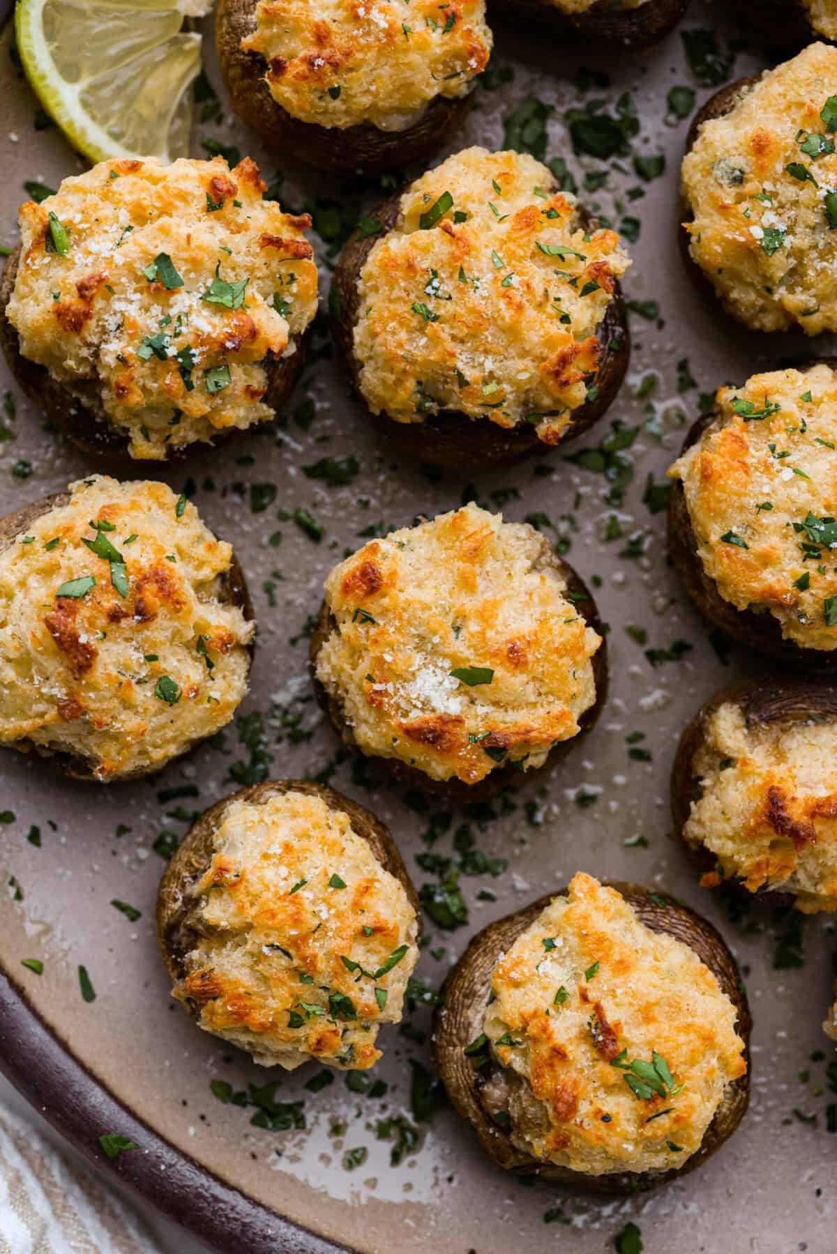 These Crab Stuffed Mushrooms are a deliciously savory appetizer, perfect for impressing guests at any gathering. With a rich crab filling in every bite, they’re sure to be a crowd favorite! Close up shot of crab stuffed mushrooms.