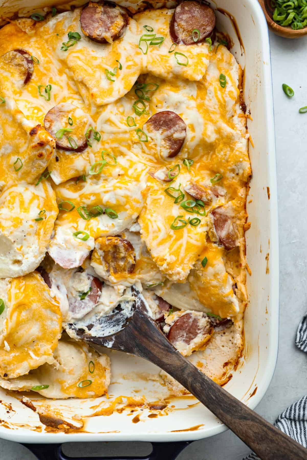 This isn’t your average Pierogi Casserole. While most stick to one type of cheese, I use a blend for ooey-gooey cheesy creaminess and cozy flavor in every bite. Overhead shot of cheesy pierogi casserole in baking dish.