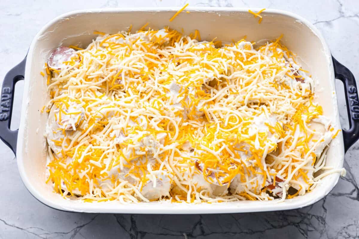 This isn’t your average Pierogi Casserole. While most stick to one type of cheese, I use a blend for ooey-gooey cheesy creaminess and cozy flavor in every bite. Pierogi casserole ingredients mixed together ready to go in the oven.