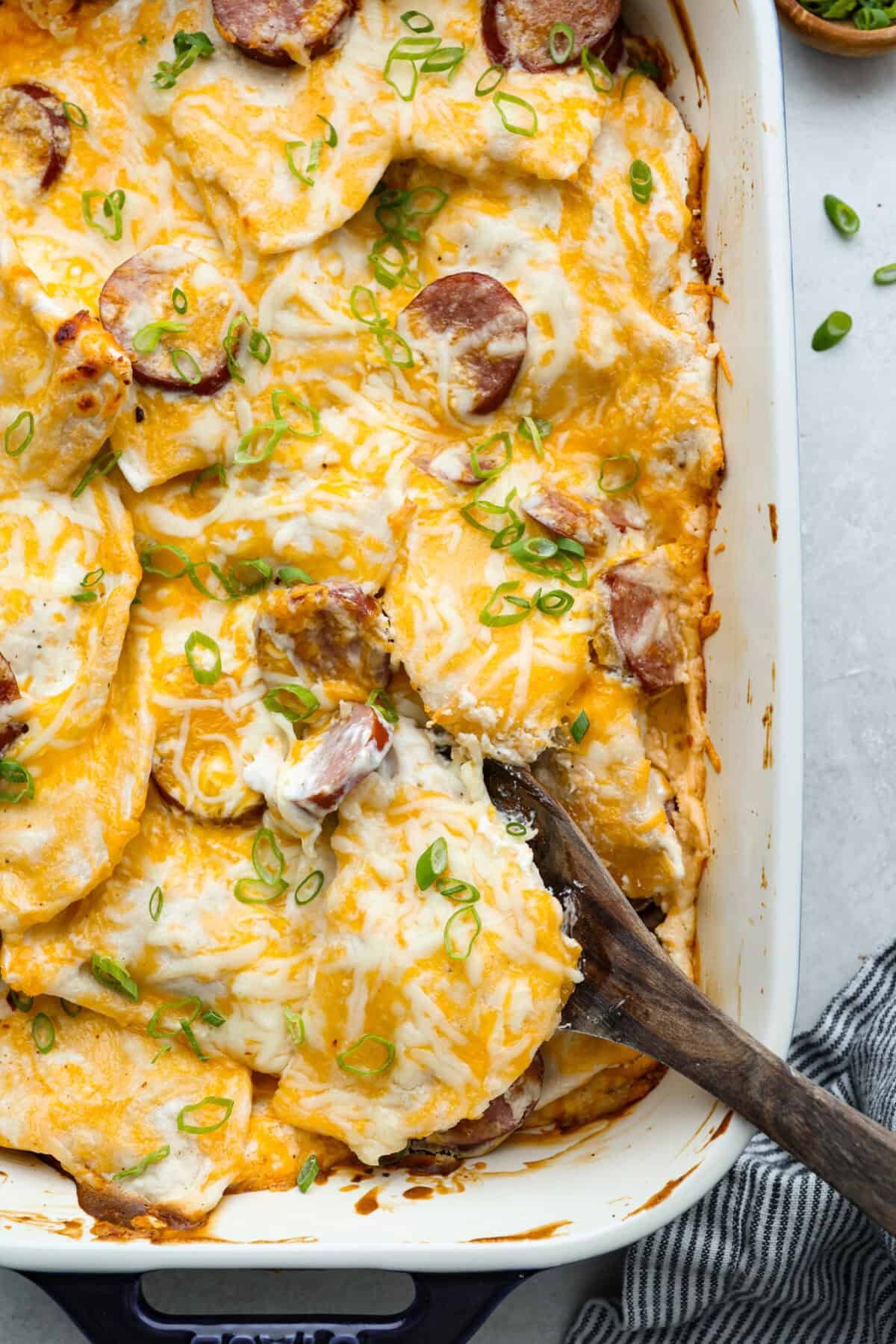 This isn’t your average Pierogi Casserole. While most stick to one type of cheese, I use a blend for ooey-gooey cheesy creaminess and cozy flavor in every bite. Close up shot of the baked dish.