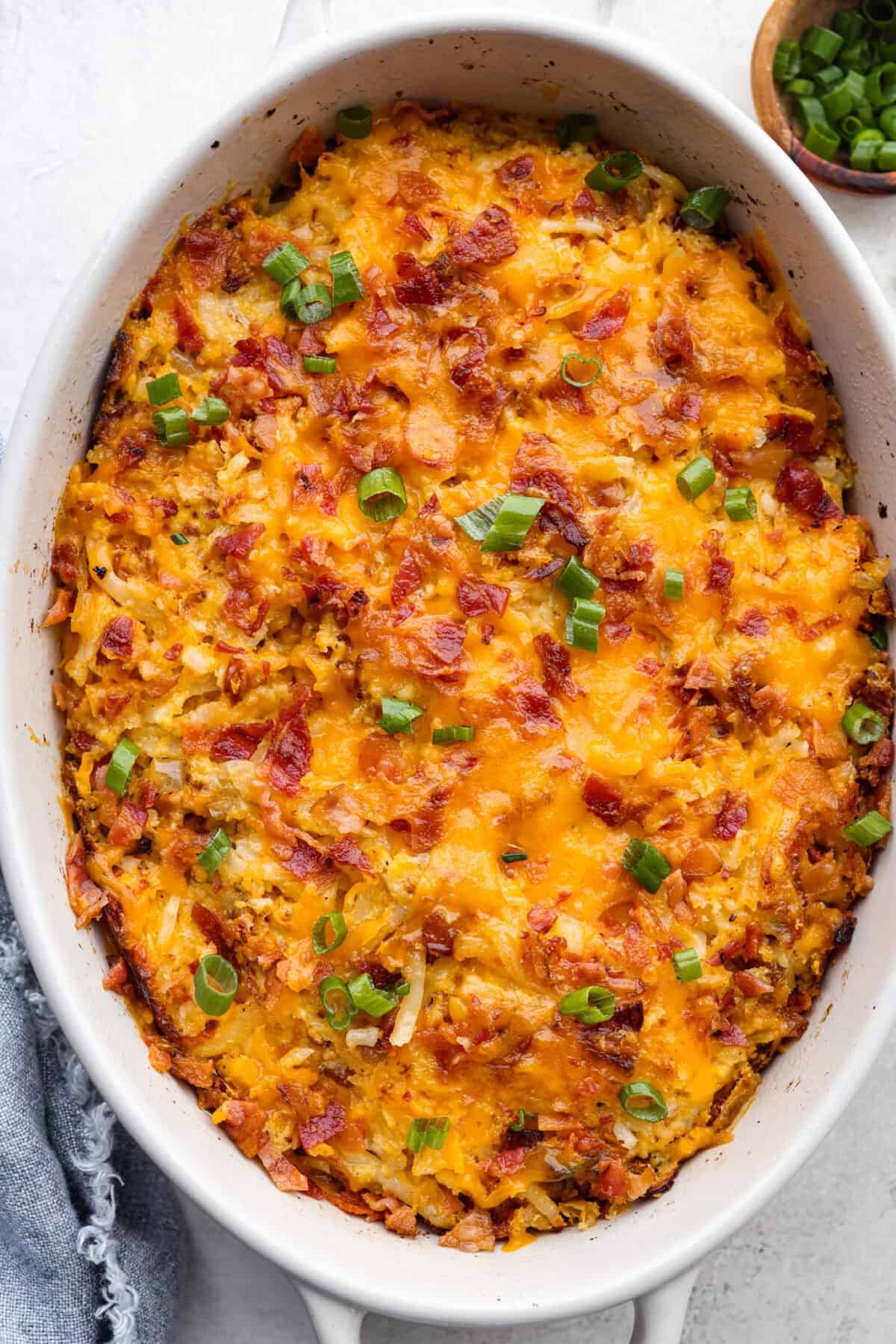 Kickstart your day with this hearty Amish Breakfast Casserole! It's loaded with crispy bacon, tender hash browns, and gooey melted cheese. This dish is a crowd-pleaser that’s perfect for family breakfasts and holiday mornings! Overhead shot of amish breakfast casserole.