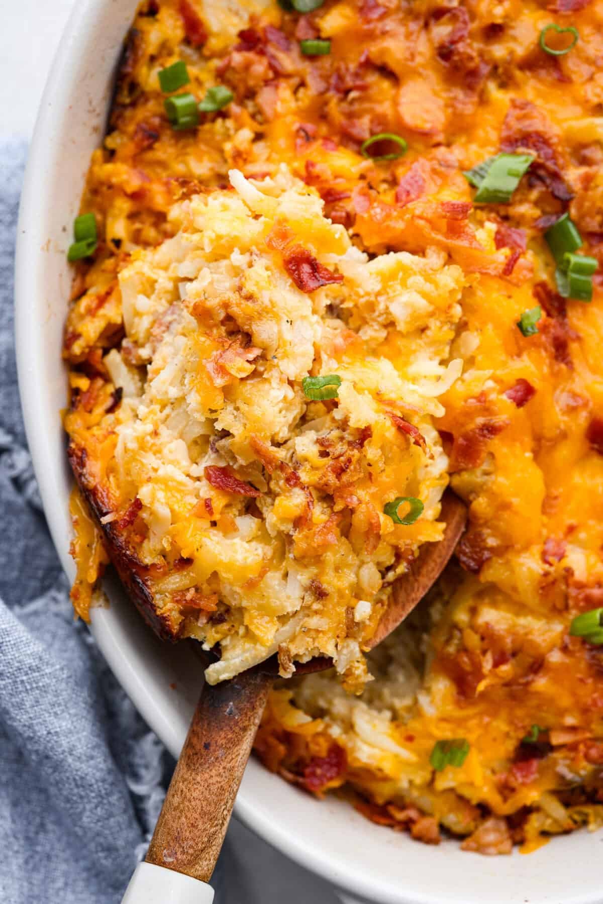 Kickstart your day with this hearty Amish Breakfast Casserole! It's loaded with crispy bacon, tender hash browns, and gooey melted cheese. This dish is a crowd-pleaser that’s perfect for family breakfasts and holiday mornings! Close up shot of amish breakfast casserole.