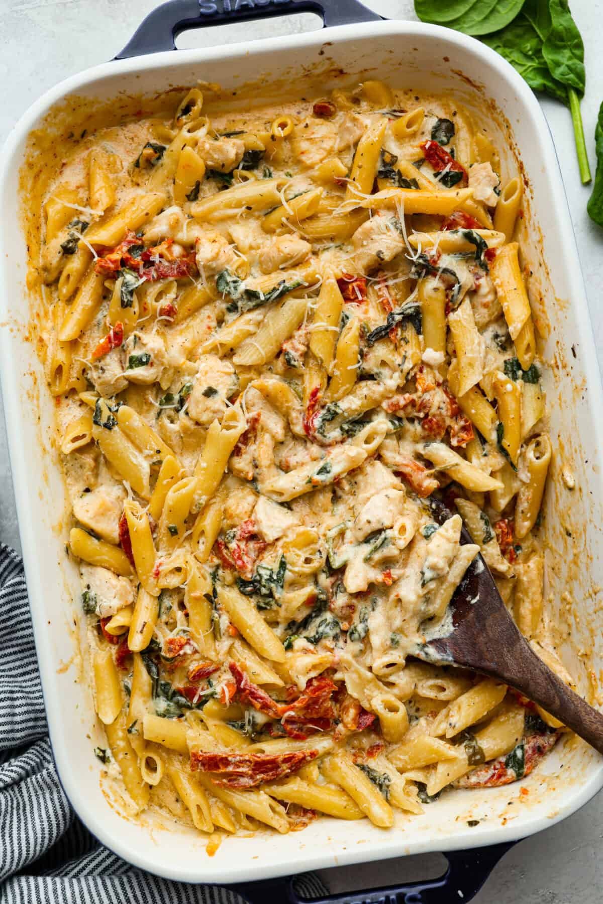 You all love my Crockpot Tuscan Chicken, and I know casseroles are a favorite as well. So, I combined them into this irresistibly delicious Tuscan Chicken Casserole! Overhead shot of baked tuscan chicken casserole.