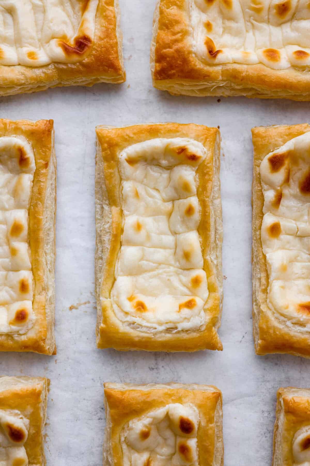 Craving the buttery goodness of a Starbucks cream cheese Danish? Now you can make it right at home! This easy copycat recipe uses flaky puff pastry and a sweet, creamy cheese filling for a treat that’s just as delicious, maybe even better! Close up shot of a Starbucks cream cheese danish from overhead.