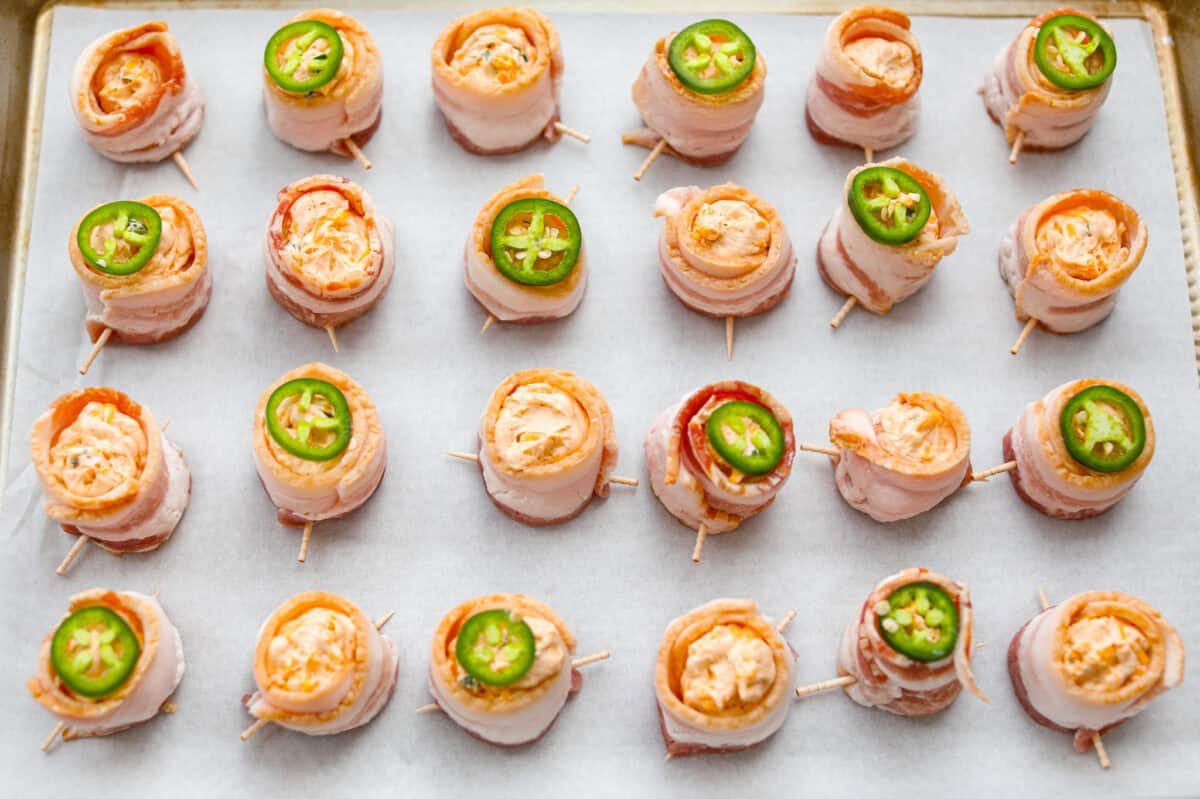 https://www.target.com/p/excalibur-seasoning-smokehouse-bbq-rub-seasoning-6oz-shaker-bottle/-/A-93218011#lnk=sametab Overhead shot of the filled, bacon wrapped sausage cups. Some of the pig shots have a slice of jalapeño on top.
