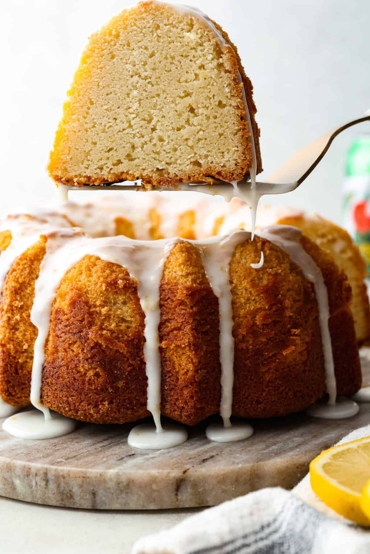 This 7UP Bundt Cake has a buttery texture with a hint of citrusy sweetness. The carbonation in 7UP lifts the batter for a light, fluffy crumb, while the lemon-lime flavor adds a bright, refreshing twist to every bite. Slice of 7UP bundt cake being lifted out of the cake on a spatula.