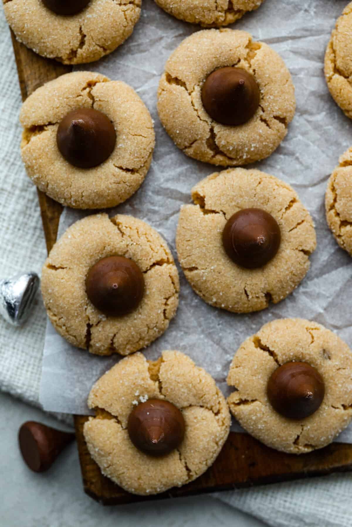 Peanut Butter Blossom Cookies are classic cookies that are perfect for every occasion. The delicious pairing of peanut butter and chocolate in these soft, buttery cookies will delight cookie lovers of all ages. Close up shot of peanut butter blossom cookies.