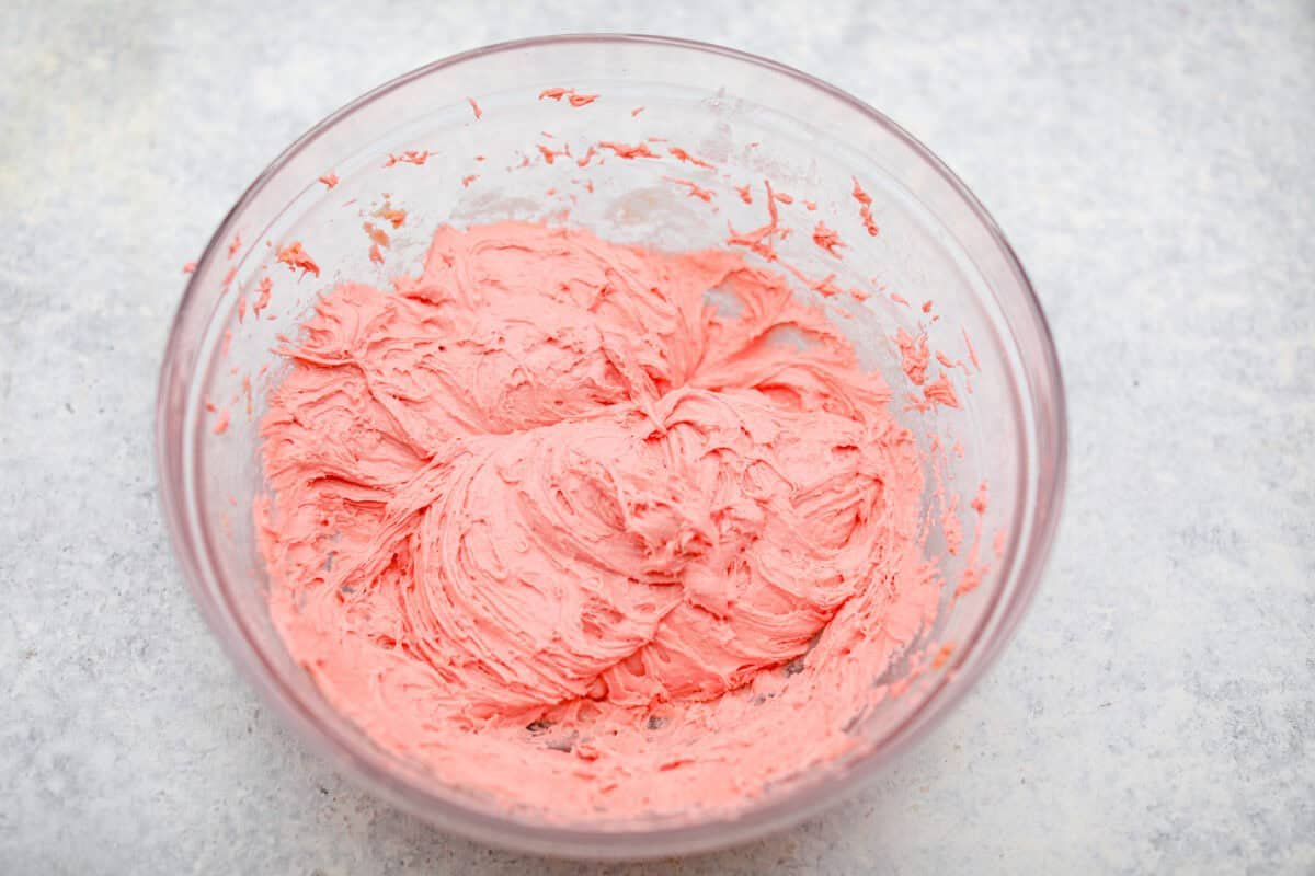 Strawberry Crinkle Cookies are the perfect blend of soft and chewy with a sweet, powdered sugar coating. Their vibrant color and classic strawberry cake flavor make them perfect for any occasion. Overhead shot of the mix whisked together.