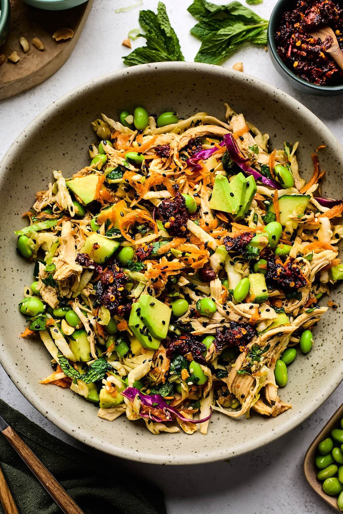 Asian chicken salad with chili crunch in bowl. 