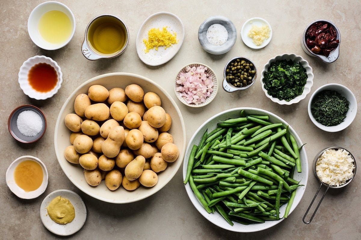ingredients in bowls to make potato and green bean salad.