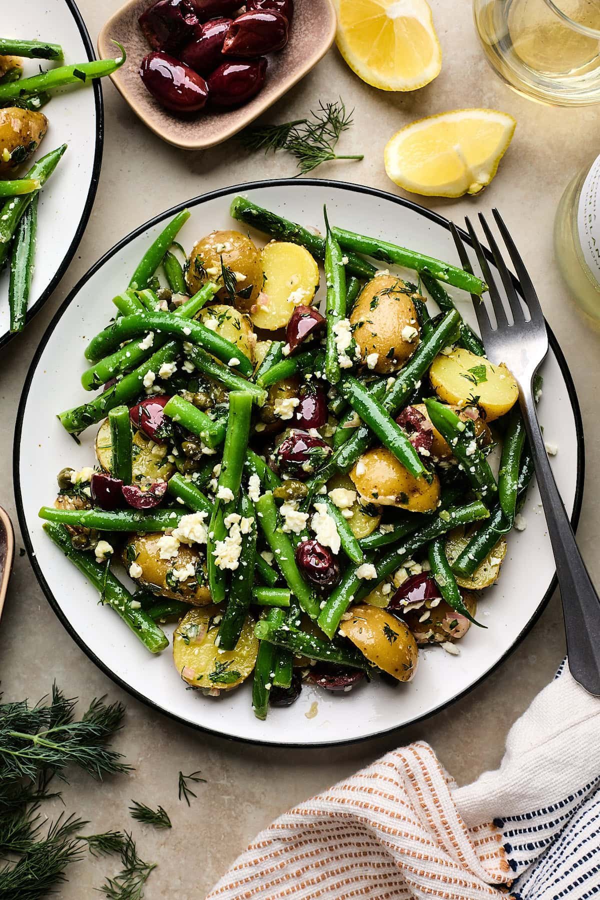 potato and green bean salad on plate with fork.