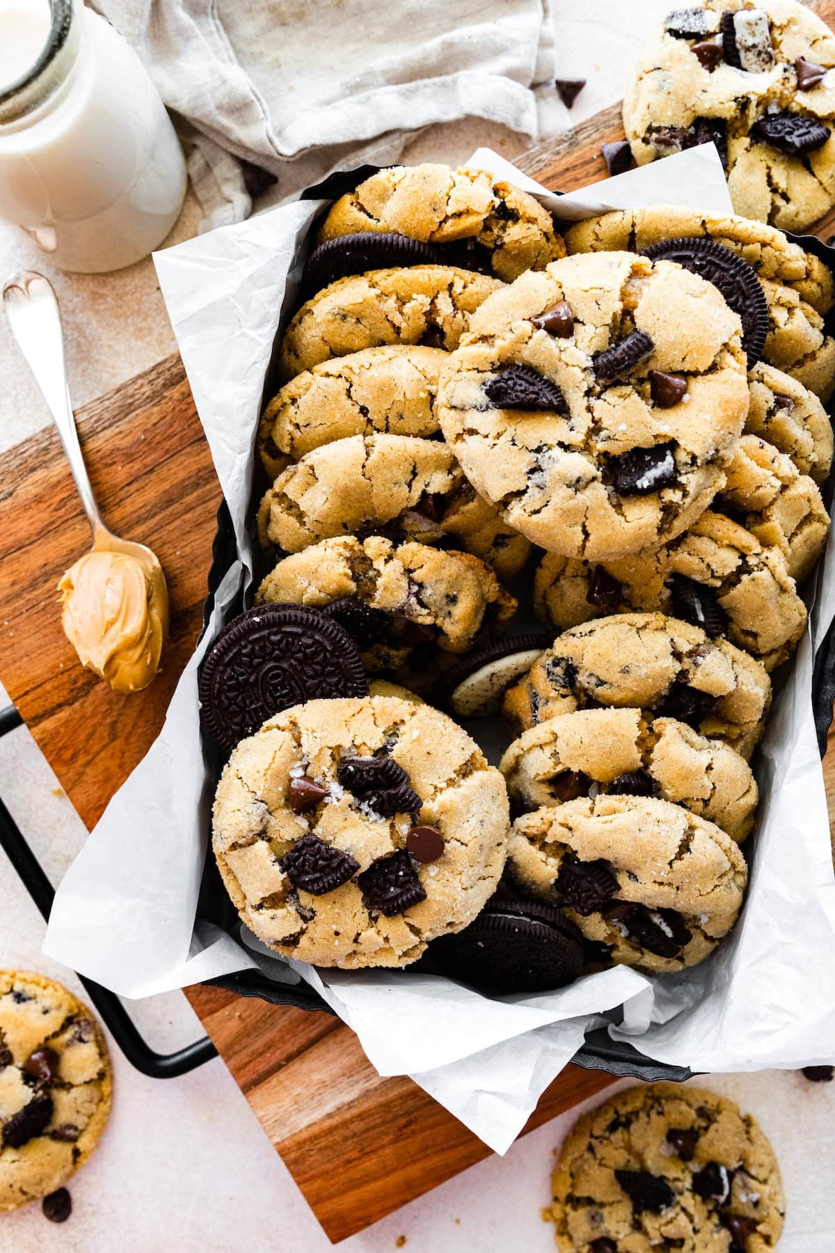 peanut butter Oreo cookies in box with parchment paper and bottle of milk.