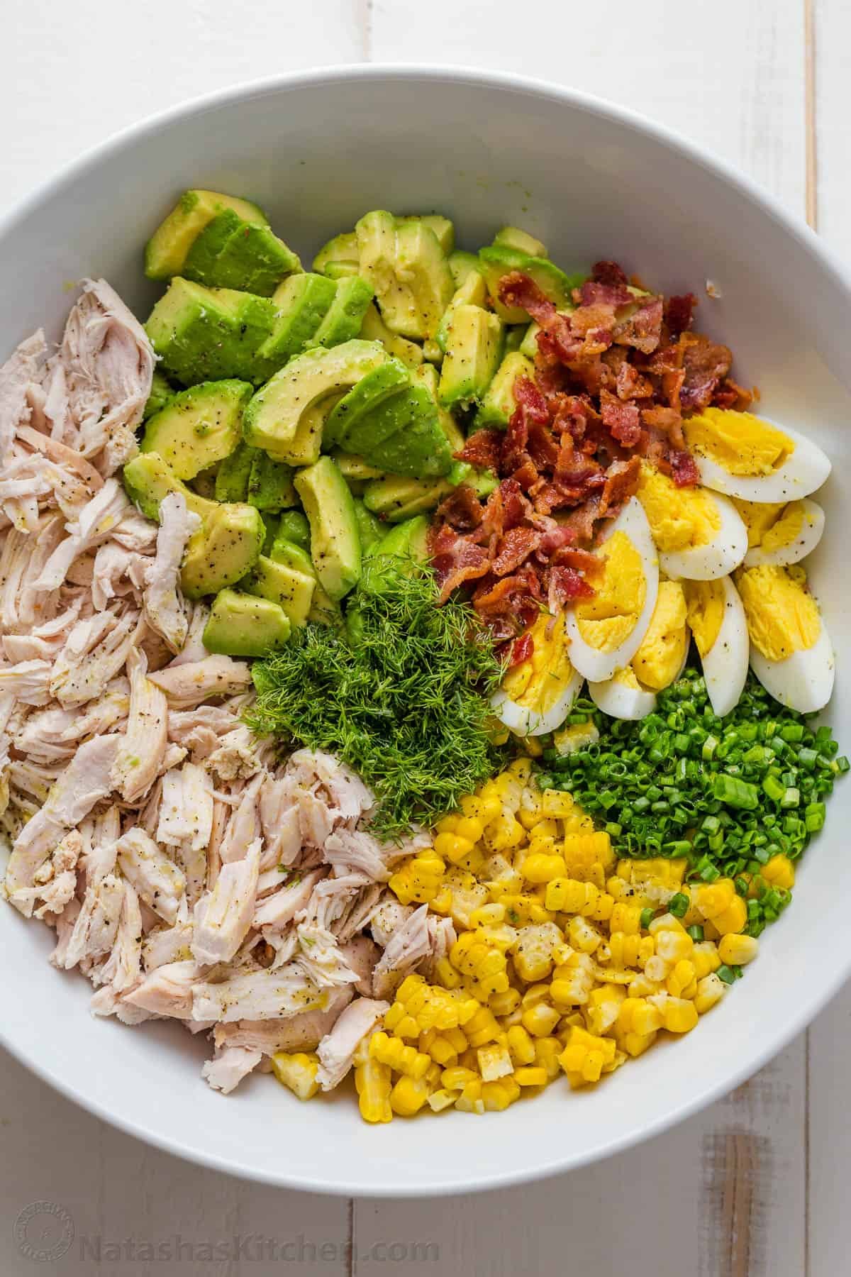 cut and shredded ingredients in a bowl for Avocado Chicken Salad