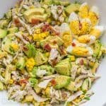 Avocado Chicken Salad topped with crumbled bacon and hard boiled eggs