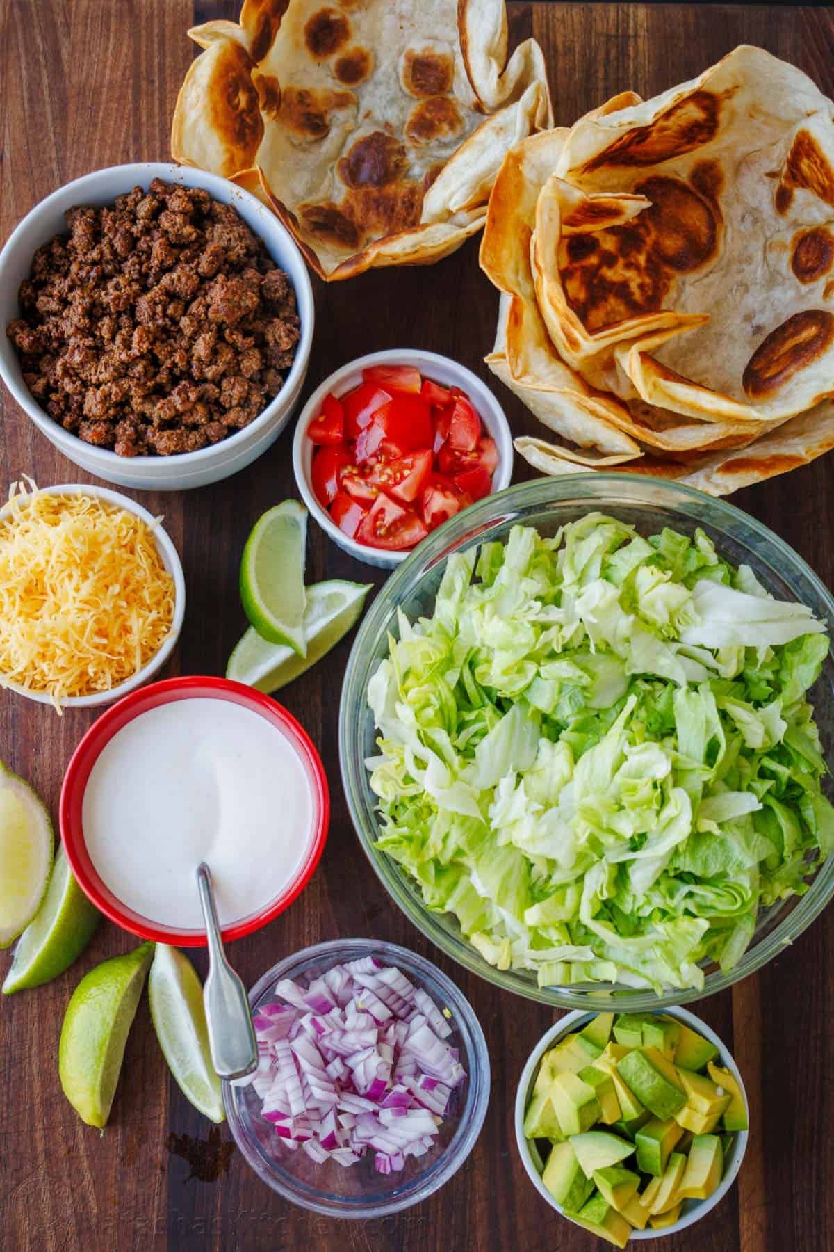 Fresh and easy Taco Salad loaded with beef, crisp lettuce, all the toppings, and the best dressing. So good served in a crispy taco salad bowl! Ingredients for Taco Salad with seasoned ground beef, shredded lettuce, taco toppings