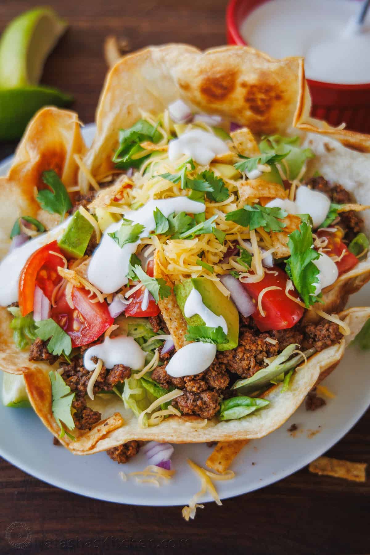 Fresh and easy Taco Salad is loaded with beef, crisp lettuce, veggies, and toppings. Easy 30-minute Taco Salad - perfect for Taco Tuesdays! Taco Salad served in a crisp tortilla bowl