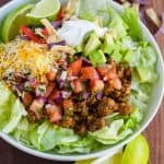 Easy taco salad served in white bowl with toppings