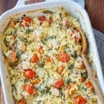 Creamy Chicken Orzo Bake Casserole with tomatoes in a white dish