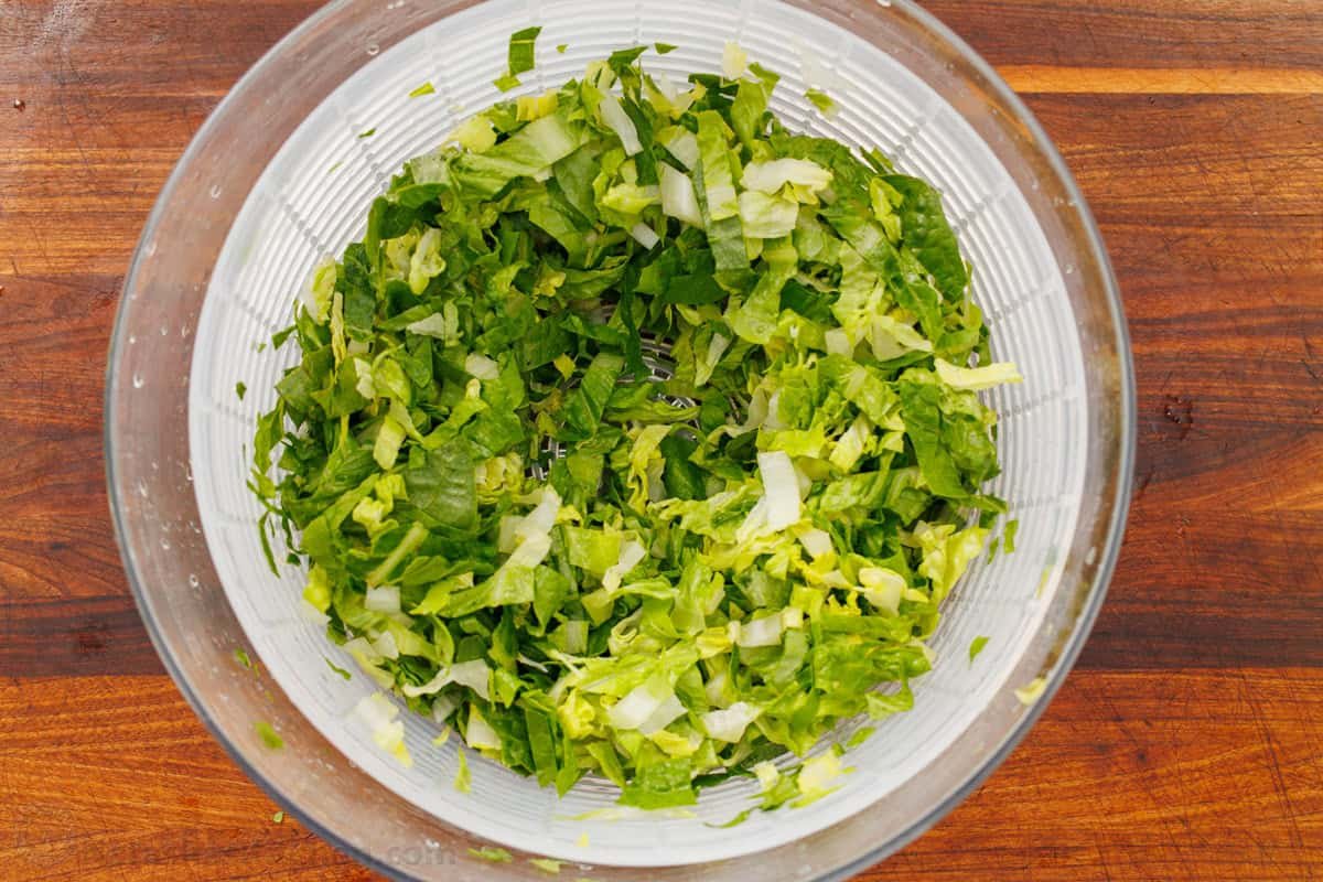 This easy traditional Maroulosalata recipe had crispy lettuce, feta cheese, and fresh herbs for a go-to Greek Lettuce Salad recipe! Romaine lettuce shreds in a salad spinner
