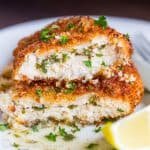 Juicy chicken kiev cut in half to show stuffing and breading