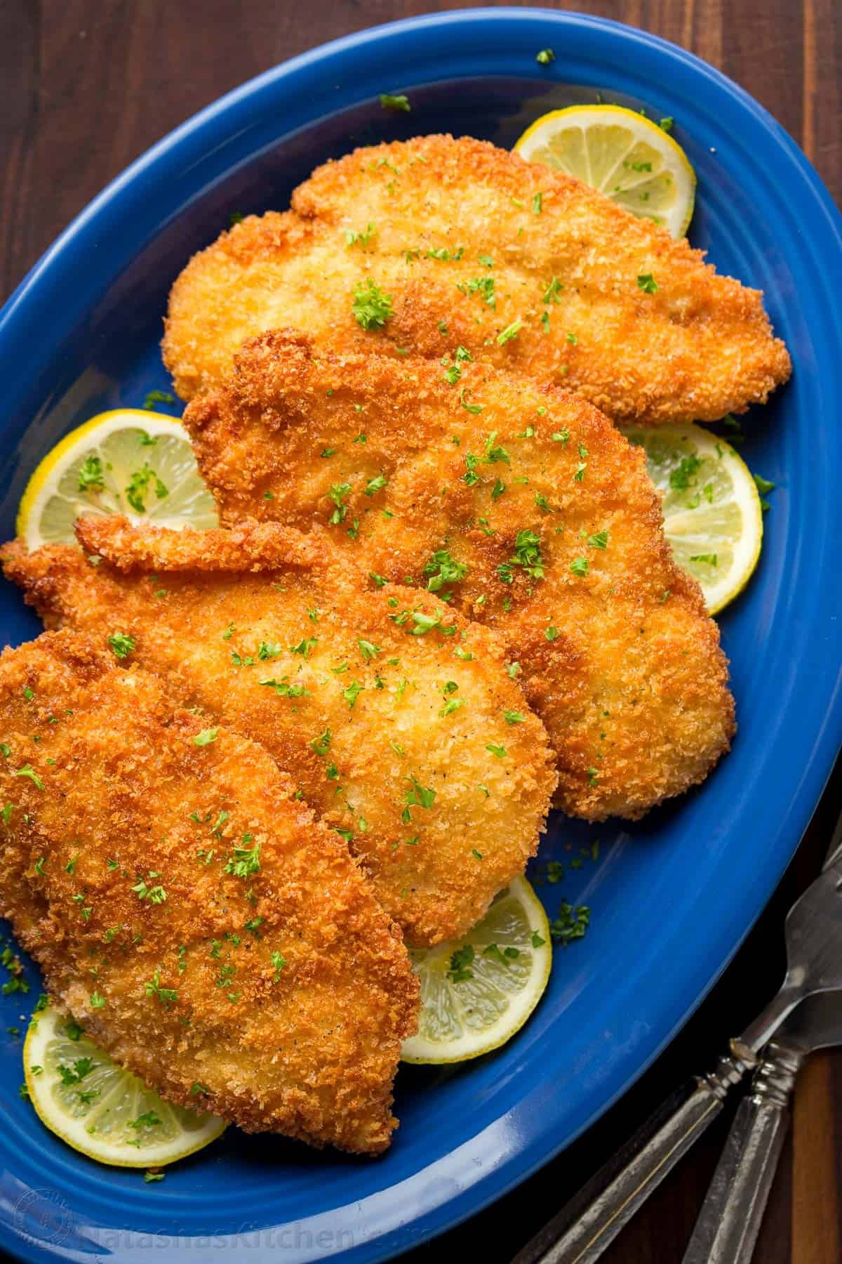 Chicken Kiev recipe on a blue plate with lemon slices