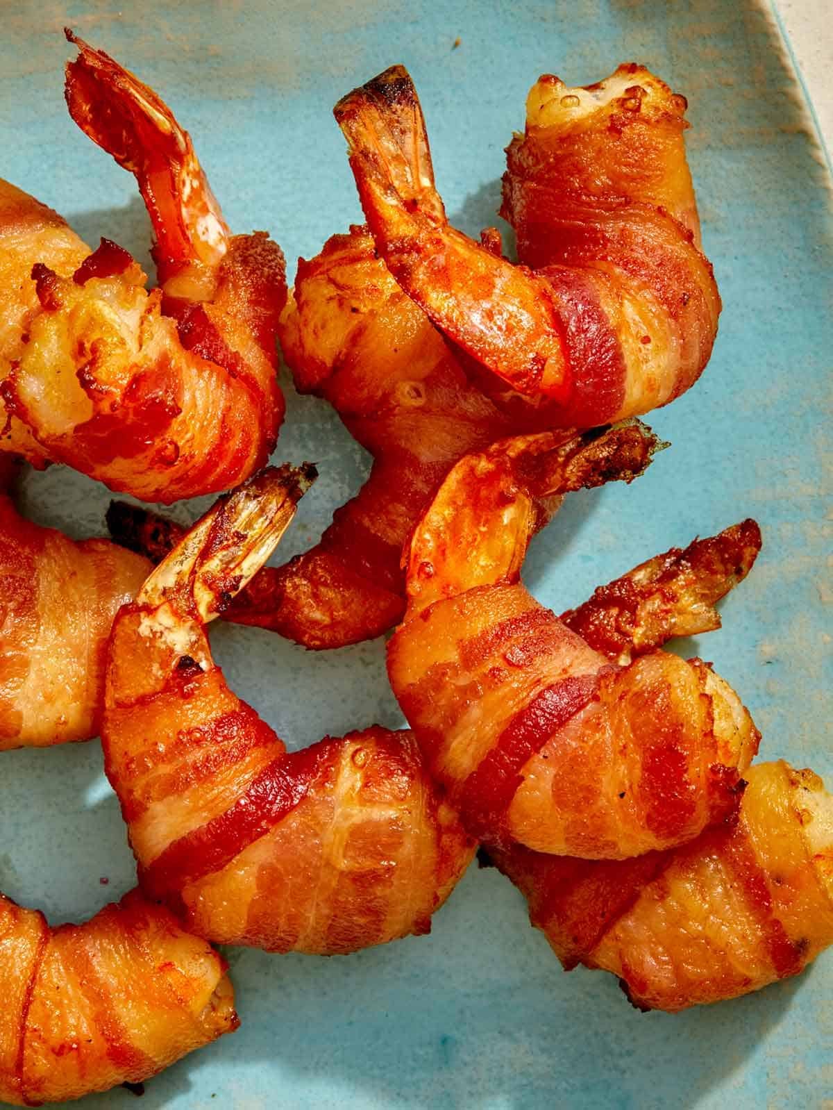 Air fryer bacon wrapped shrimp on a platter.