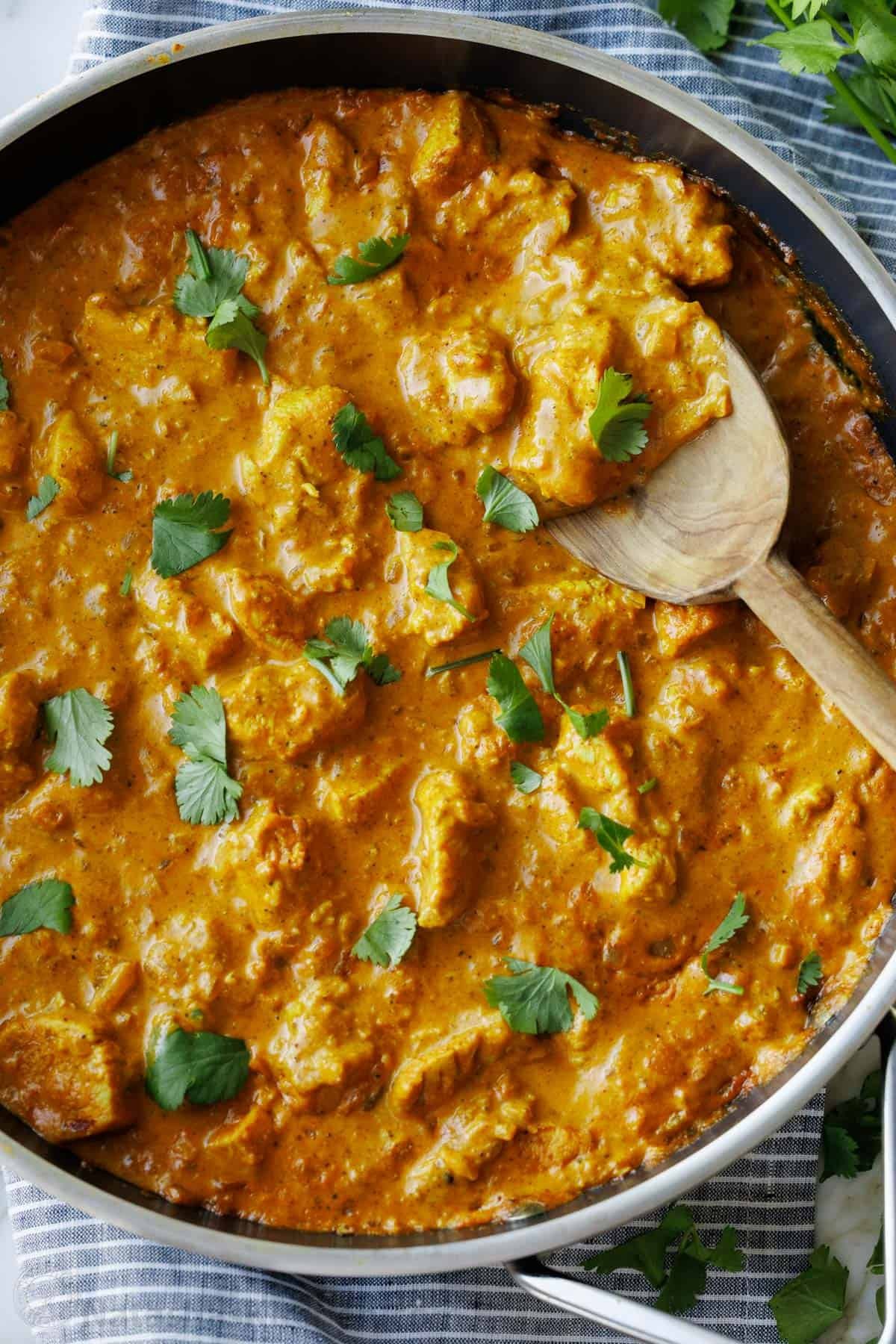 Chicken Korma is rich, creamy, and full of warm spices. This easy yet impressive dish brings the flavors of India to your kitchen. Serve over rice and enjoy! Chunks of cooked chicken simmered in Korma sauce, and garnished with cilantro. This Chicken Korma dish is a mild curry and perfect served over white rice.