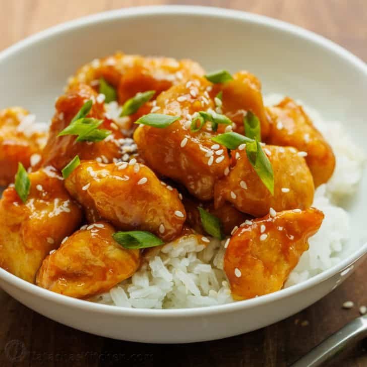 Honey Garlic Chicken cubed and served over white rice, topped with sesame seeds and green onion.