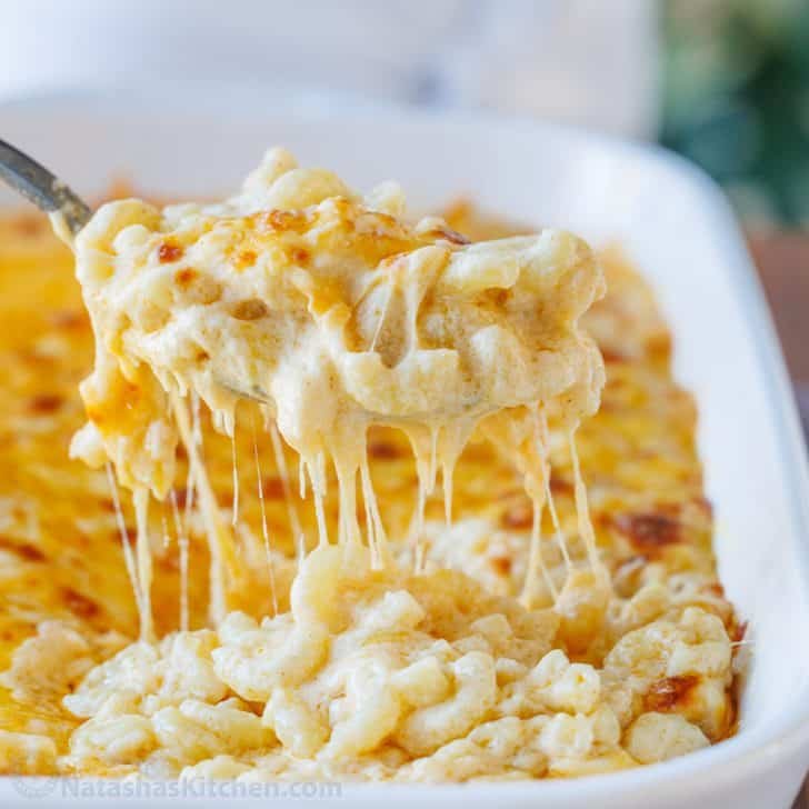 Baked mac and cheese served with a spoon from casserole dish