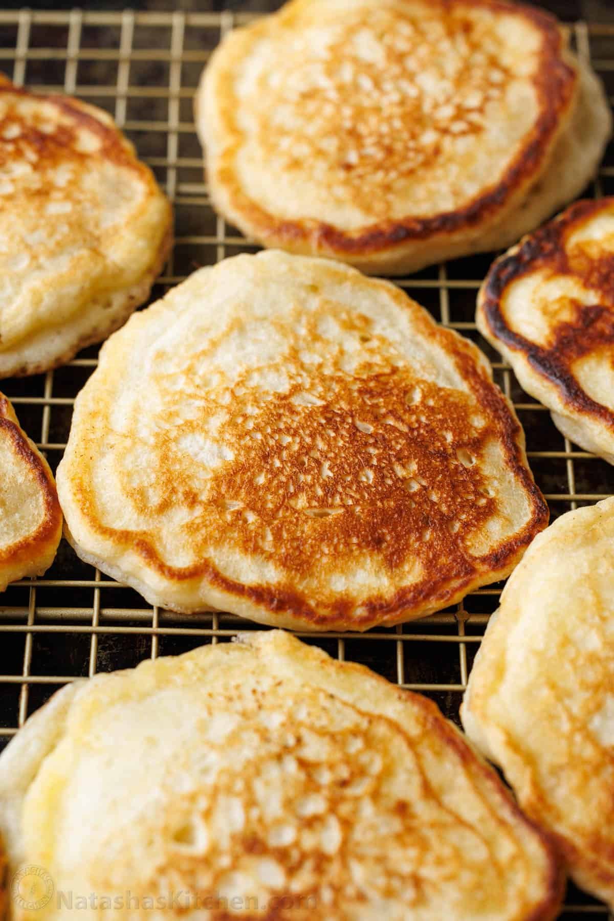 Overnight Sourdough Pancakes are an easy make-ahead breakfast! Mix everything before bed and wake up to bubbly, ready-to-cook pancake batter. Make-ahead sourdough pancakes cooling on a rack