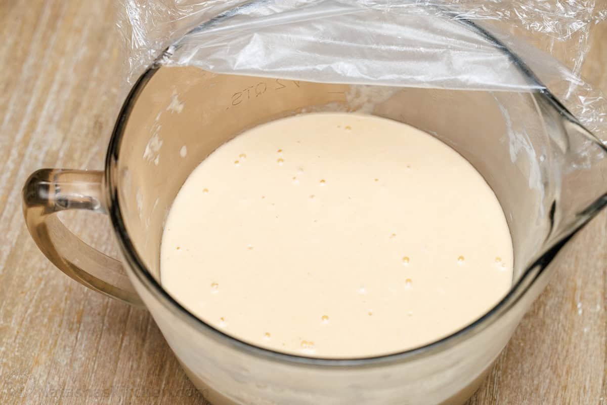 Sourdough Pancake batter fermented overnight with lots of bubbles. bubbles on the surface of overnight pancake batter