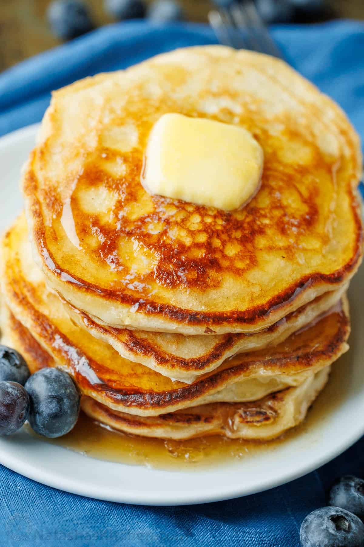 Overnight Sourdough Pancakes are easy! Mix everything before bed, leave at room temp overnight, and wake up to bubbly, ready-to-cook pancake batter. Sourdough pancakes served with fresh blueberries