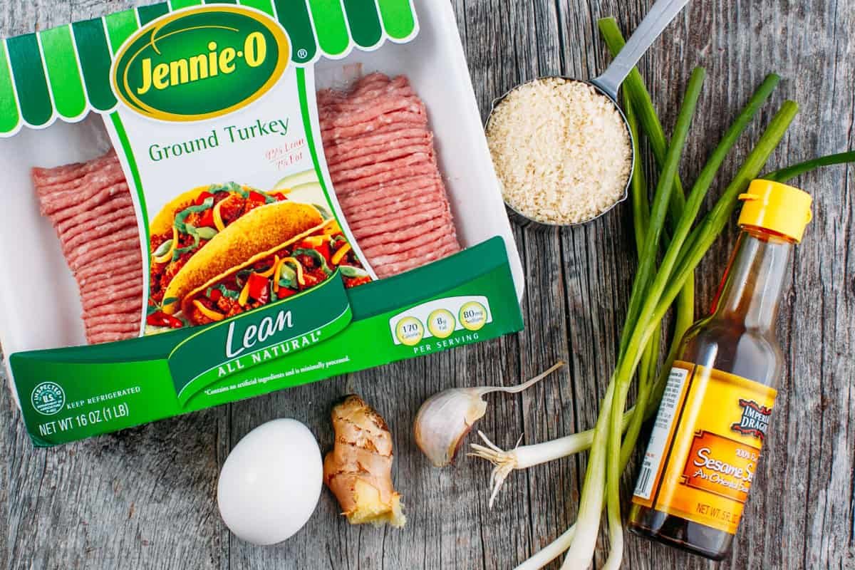 30-minute Turkey Teriyaki Meatballs are just as juicy with less guilt! Simply bake the meatballs and cover them with homemade teriyaki glaze. ingredients for healthier ground turkey main dish or appetizer including turkey, panko, egg, ginger, garlic, green onions and sesame oil