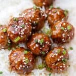 Teriyaki Meatballs served over rice with sesame seeds and chive garnish