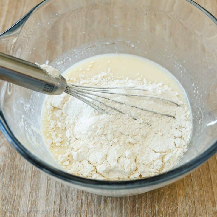 Sourdough Pancakes are a delightful twist on the classic breakfast favorite, with a soft and spongy texture and great sourdough flavor. Whisking buttermilk and flour together in a glass bowl