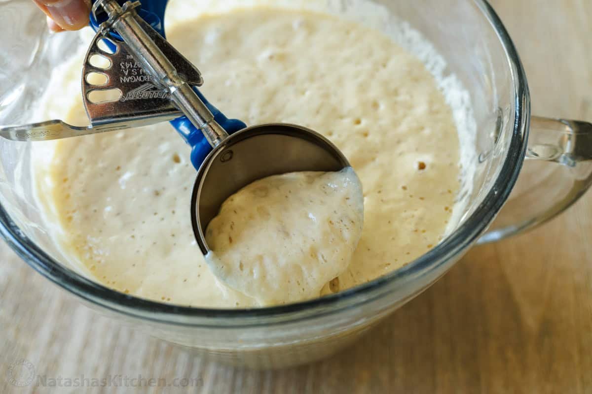 Sourdough Pancakes are a delightful twist on the classic breakfast favorite, with a soft and spongy texture and great sourdough flavor. scooping sourdough discard pancake batter with ice cream scoop