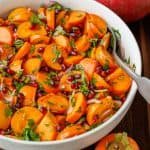 Persimmon pomegranate salad in white salad bowl