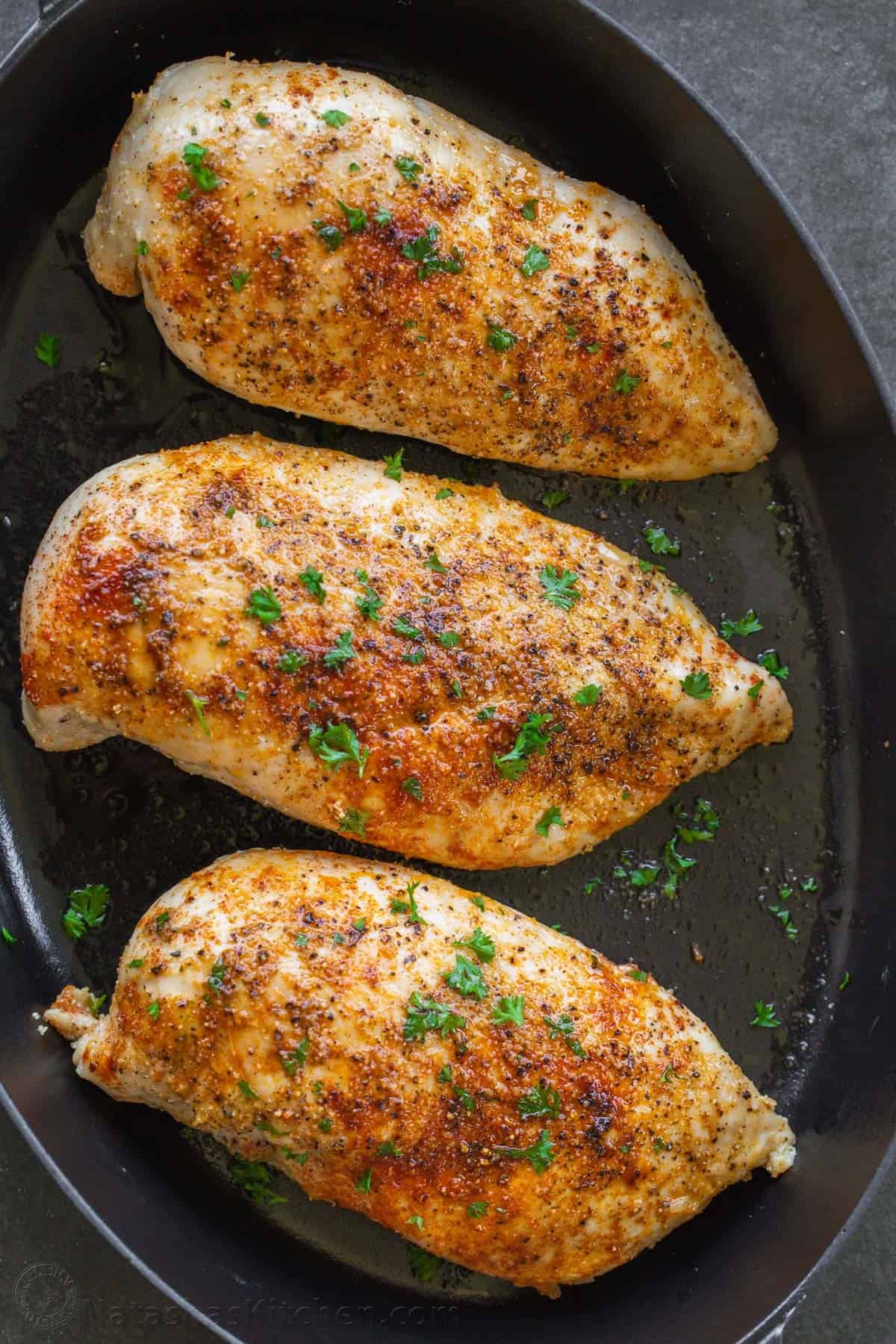 This Baked Chicken Breast is tender, juicy, and perfectly seasoned - versatile and great for meal prep! Say goodbye to dry, boring chicken! Baked Chicken Breasts seasoned and arranged in a casserole dish