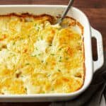 Golden baked au gratin potatoes in a rectangular baking dish.