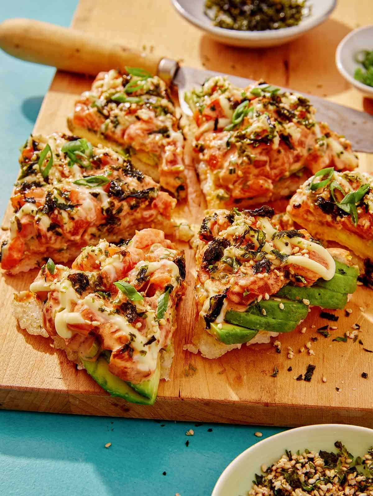 Sushi pizza cut into slices. 