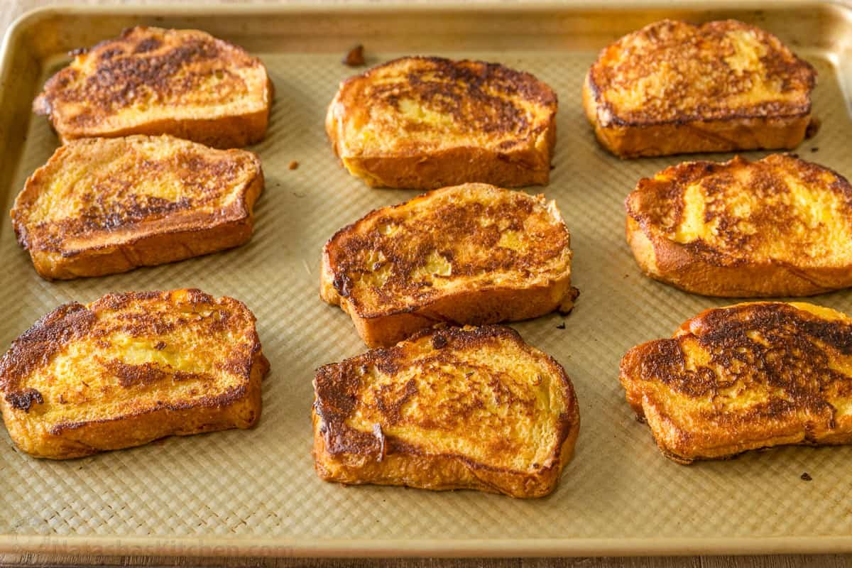 This French Toast is crisp at the edges with a tender, custard-like center. Watch the easy video and learn how to make the best French Toast. Make ahead French Toast on a baking sheet