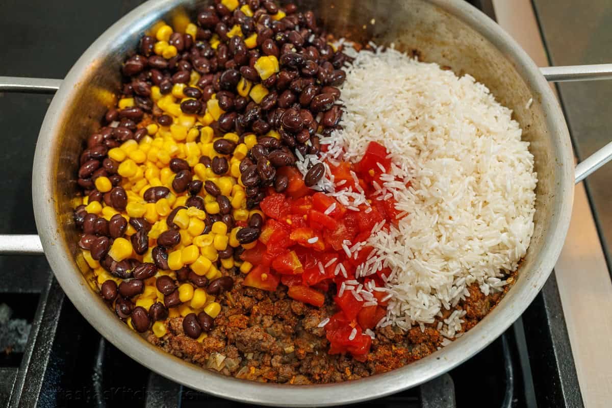 Mexican Beef and Rice Skillet is a quick, 30-minute meal—seasoned beef, loaded rice, and gooey melted cheese. The perfect one-pan wonder! Mexican Ground Beef and Rice Skillet with the black beans, corn, rice, and Rotel tomatoes added to the ground beef.